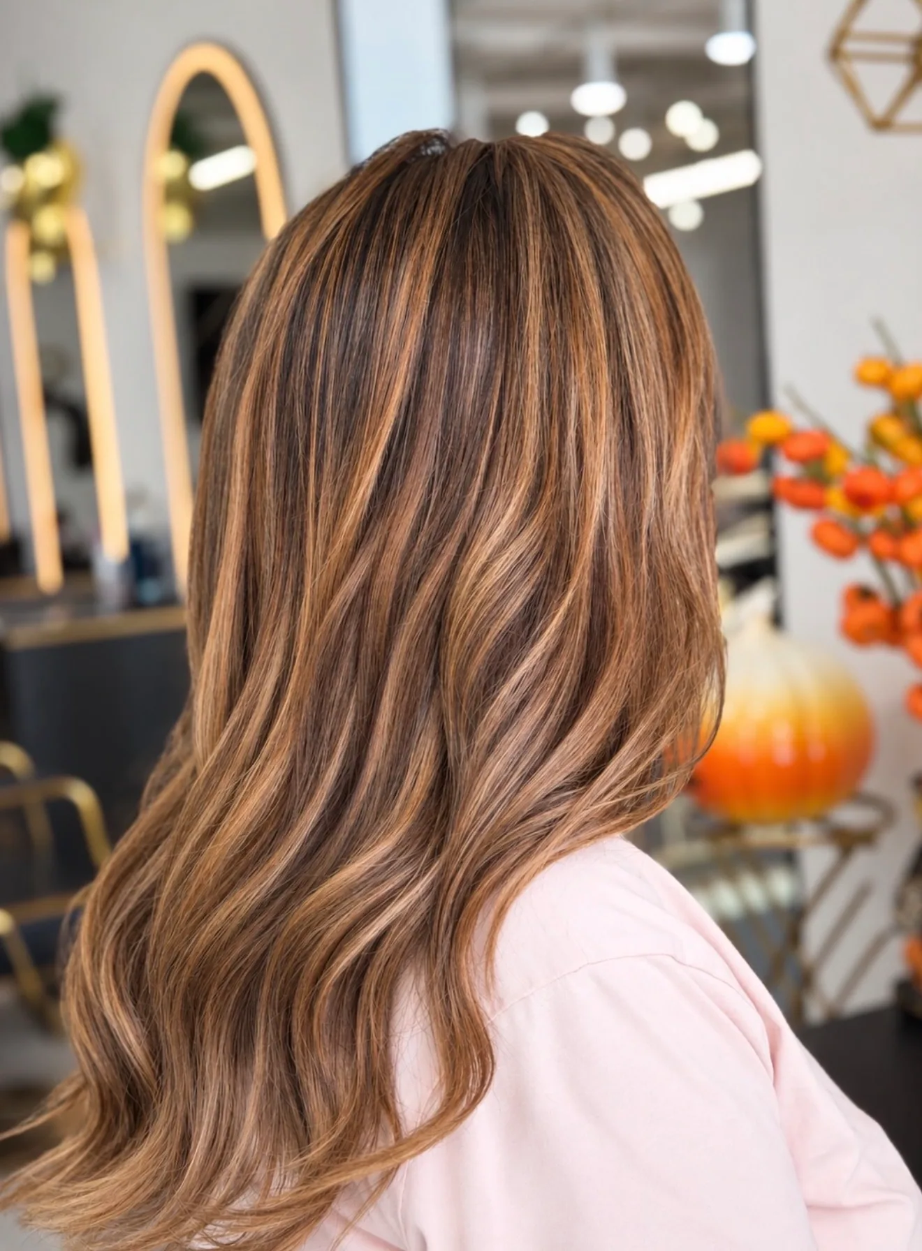 Dimensional brunette hair color with warm caramel highlights at Pacific Hair & Beauty